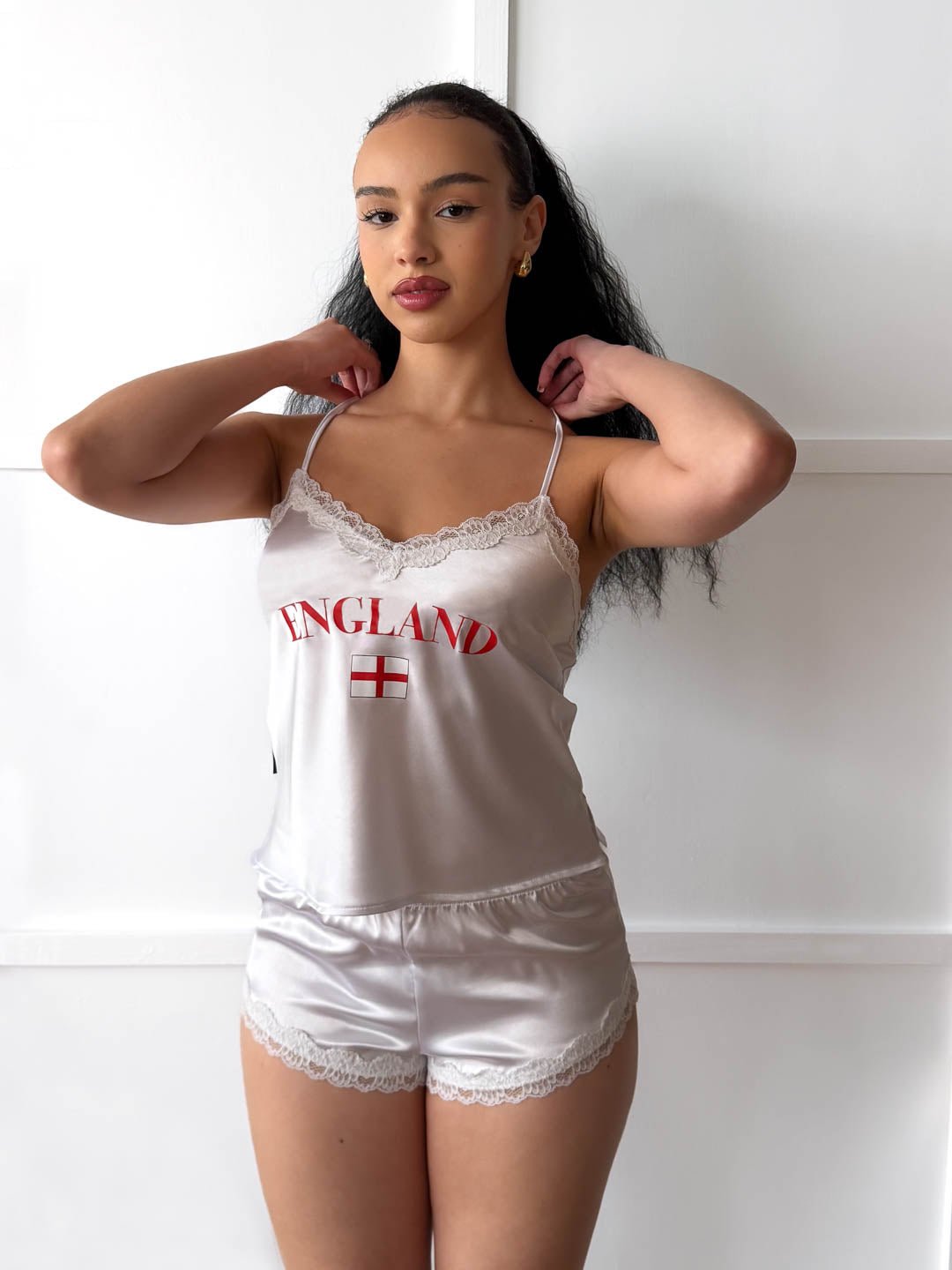 Model wearing a white satin camisole and shorts pyjama set with England flag and country name print.